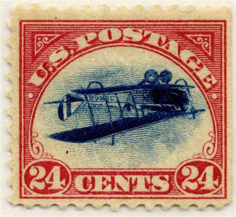 A US Postage 24 cent stamp with an upside down bi-plane illustration in the middle of the stamp