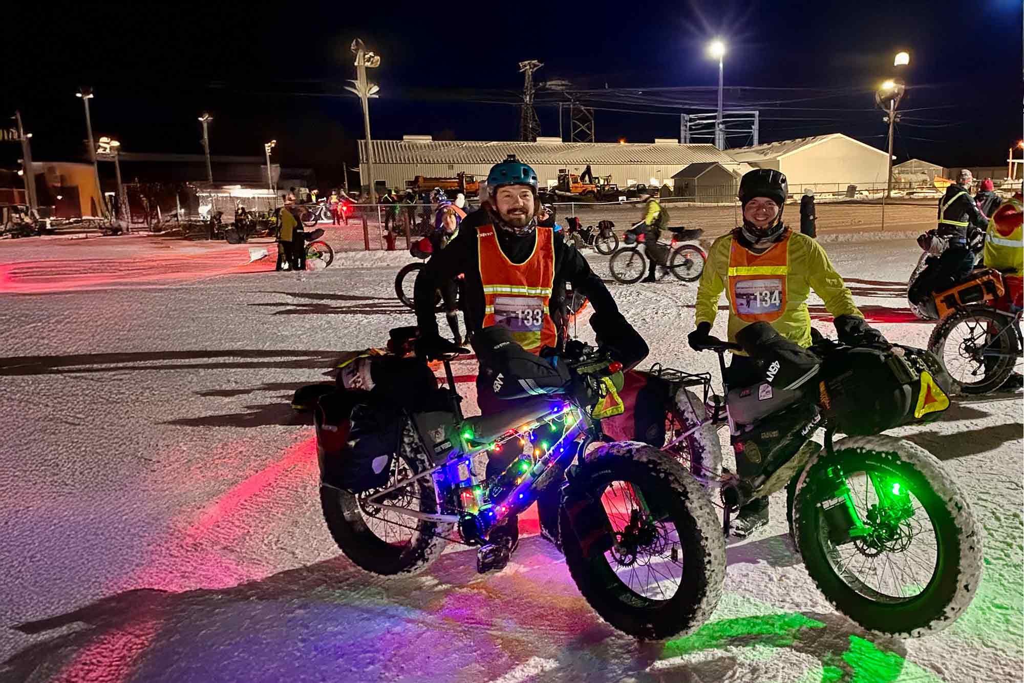 Price brothers standing together with loaded Surly Moonlander fat bikes at Arrowhead 135 start