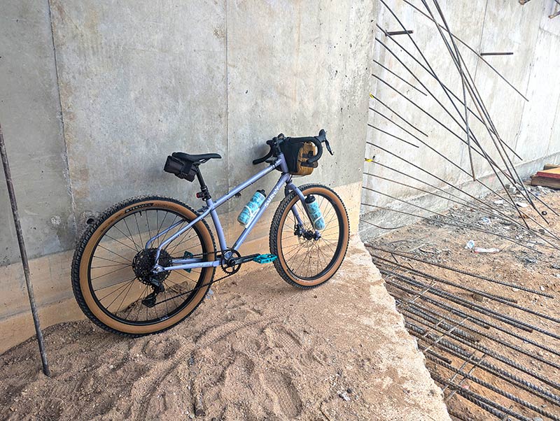 Surly Grappler resting against wall, Purple Dust Bunny color